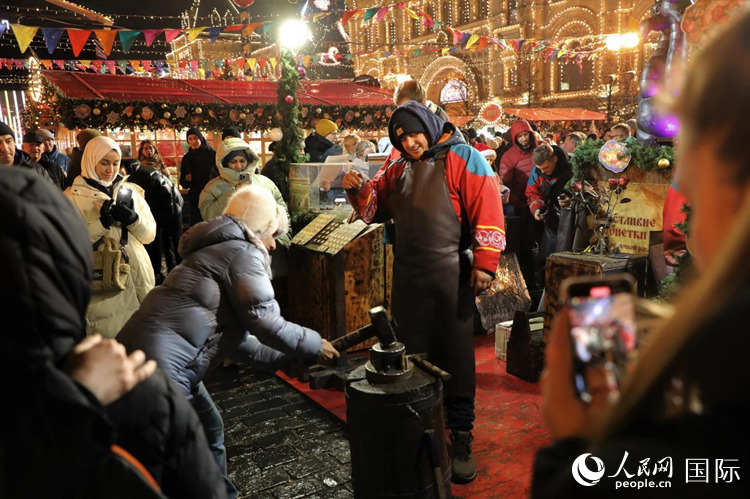 游客在新年集市上體驗制作紀念幣。人民網記者 隋鑫攝